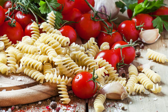dry-pasta-fusilli-with-tomatoes-selective-focus